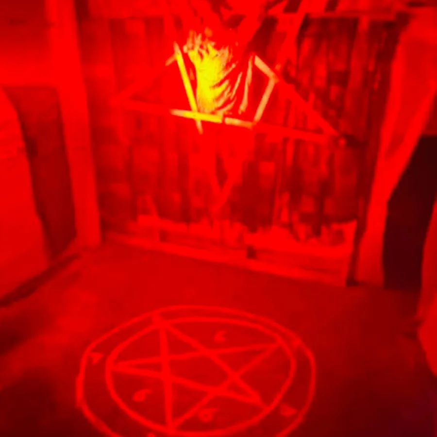 A red-lit room with occult symbols inside the haunt.